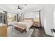 Spacious bedroom with a light color scheme, tray ceiling, and many windows at 10600 Se 32Nd Ave, Ocala, FL 34480