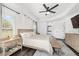 Bedroom with hardwood floors, tray ceiling, and side access to the primary bathroom at 10600 Se 32Nd Ave, Ocala, FL 34480