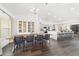 Bright dining room with modern chandelier, sleek dining table, and stylish built-in display cabinet at 10600 Se 32Nd Ave, Ocala, FL 34480