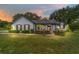 Charming single-story home featuring tidy landscaping, a covered porch, and elegant exterior lighting at 10600 Se 32Nd Ave, Ocala, FL 34480