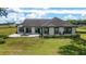 Back exterior of home with patio and outdoor seating at 10600 Se 32Nd Ave, Ocala, FL 34480