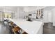 Open kitchen with a large white quartz island, modern appliances, and stylish bar stool seating at 10600 Se 32Nd Ave, Ocala, FL 34480