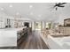 Expansive living space flowing from the kitchen to the living area with bar seating and wood floors at 10600 Se 32Nd Ave, Ocala, FL 34480