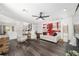 Open concept living room with hardwood floors, modern decor, and an adjacent kitchen at 10600 Se 32Nd Ave, Ocala, FL 34480