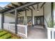Inviting front porch featuring a swing, ceiling fan and decorative accents at 10600 Se 32Nd Ave, Ocala, FL 34480