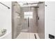 Modern shower stall with glass door, rainfall shower head, and stylish tile at 10600 Se 32Nd Ave, Ocala, FL 34480
