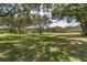 Open, grassy property dotted with mature trees, providing plenty of space and a natural landscape at 10600 Se 32Nd Ave, Ocala, FL 34480