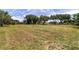 Large grassy lot featuring mature trees scattered across the landscape, with other homes visible in the distance at 10600 Se 32Nd Ave, Ocala, FL 34480