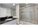 Modern bathroom with a shower and bathtub combination with black granite countertop at 10758 Se Highway 464C, Ocklawaha, FL 32179