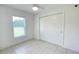 Bedroom with tile flooring, a window, and closet with sliding doors at 10758 Se Highway 464C, Ocklawaha, FL 32179