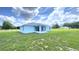 Exterior view of the home with a screen porch and backyard at 10758 Se Highway 464C, Ocklawaha, FL 32179