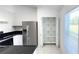 Kitchen featuring stainless steel refrigerator, dark countertops, tile flooring, and walk-in pantry at 10758 Se Highway 464C, Ocklawaha, FL 32179