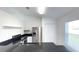 Kitchen featuring stainless steel refrigerator, dark countertops, tile flooring, and stainless steel appliances at 10758 Se Highway 464C, Ocklawaha, FL 32179