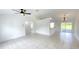 Bright living room with neutral walls, ceiling fan, chandelier and sliding glass doors at 10758 Se Highway 464C, Ocklawaha, FL 32179