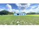 Charming single-story home featuring a rear exterior view with a spacious backyard and bright blue paint at 10758 Se Highway 464C, Ocklawaha, FL 32179