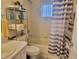 Bathroom with a shower-tub combo, white tile, decorative curtain, and vanity at 10945 Sw 75Th Ave, Ocala, FL 34476