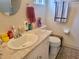 Bathroom featuring a granite vanity with a sink and a coordinated toilet at 10945 Sw 75Th Ave, Ocala, FL 34476