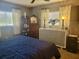 Bedroom featuring natural light from two windows, dressers and a comfy bed at 10945 Sw 75Th Ave, Ocala, FL 34476