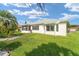 Spacious backyard with a well-maintained lawn and a view of the home's exterior at 12489 Se 90Th Ter, Summerfield, FL 34491