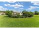 Beautiful backyard with lush green grass and mature trees at 12489 Se 90Th Ter, Summerfield, FL 34491
