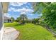 Well-manicured backyard featuring lush green grass and decorative landscaping at 12489 Se 90Th Ter, Summerfield, FL 34491