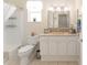 Bathroom featuring tub with shower, white vanity with a beige countertop, and neutral tiling at 12489 Se 90Th Ter, Summerfield, FL 34491