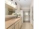 Bright bathroom featuring a double vanity and a large shower with glass doors at 12489 Se 90Th Ter, Summerfield, FL 34491