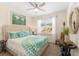 Bright bedroom featuring coordinated bedding, soft natural light, and view through shuttered window at 12489 Se 90Th Ter, Summerfield, FL 34491
