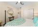 Comfortable bedroom with stylish decor, including a decorative mirror and coordinated bedding at 12489 Se 90Th Ter, Summerfield, FL 34491