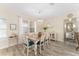 Cozy dining room featuring a chandelier, bright windows, and a mirrored sideboard for elegant entertaining at 12489 Se 90Th Ter, Summerfield, FL 34491