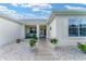 Inviting home entrance with decorative landscaping, welcoming front porch at 12489 Se 90Th Ter, Summerfield, FL 34491