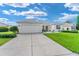 Home with a well-maintained lawn and beautiful landscaping at 12489 Se 90Th Ter, Summerfield, FL 34491