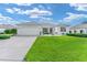 Charming home with a well-kept lawn and manicured landscaping at 12489 Se 90Th Ter, Summerfield, FL 34491