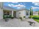 Charming home entrance with decorative landscaping and inviting front porch seating at 12489 Se 90Th Ter, Summerfield, FL 34491