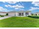 Well-maintained front yard with lush green grass and landscaped garden beds at 12489 Se 90Th Ter, Summerfield, FL 34491