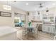 Bright eat-in kitchen featuring modern appliances, white cabinetry, and a view of the screened-in lanai at 12489 Se 90Th Ter, Summerfield, FL 34491