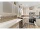 The bright kitchen features stainless appliances, tile backsplash, and solid surface counters at 12489 Se 90Th Ter, Summerfield, FL 34491