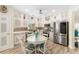 Modern kitchen featuring stainless steel appliances, tile backsplash, and a cozy eat-in area at 12489 Se 90Th Ter, Summerfield, FL 34491