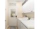 Functional laundry room with washer, dryer, and cabinetry for ample storage at 12489 Se 90Th Ter, Summerfield, FL 34491
