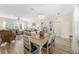 Spacious open-plan living area featuring a dining table and comfortable seating ideal for entertaining at 12489 Se 90Th Ter, Summerfield, FL 34491