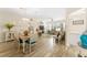 Bright open-plan living area with dining table and comfortable seating perfect for entertaining and relaxing at 12489 Se 90Th Ter, Summerfield, FL 34491
