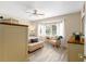 Bright main bedroom with a ceiling fan, a bench, and lots of natural light at 12489 Se 90Th Ter, Summerfield, FL 34491