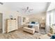 Bright main bedroom featuring a ceiling fan, lots of natural light, and light colored walls at 12489 Se 90Th Ter, Summerfield, FL 34491