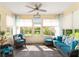 Bright sunroom featuring neutral flooring and comfortable seating at 12489 Se 90Th Ter, Summerfield, FL 34491
