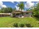 Exterior rear view of a house with a fenced yard and covered patio at 1330 Ne 55Th St, Ocala, FL 34479