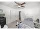 Bright bedroom with carpet, window, black dresser, white metal bed and white walls at 1330 Ne 55Th St, Ocala, FL 34479