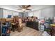 Large bedroom featuring two windows, ceiling fan, wood look floors and lots of stored items at 1330 Ne 55Th St, Ocala, FL 34479