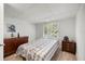 Bright bedroom featuring wood floors, a window, and classic wooden furniture at 1330 Ne 55Th St, Ocala, FL 34479