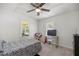 White bedroom with natural light, desk and television. The room is carpeted at 1330 Ne 55Th St, Ocala, FL 34479