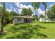 Well-kept home with a metal roof, covered front porch, and spacious yard with mature trees at 1330 Ne 55Th St, Ocala, FL 34479